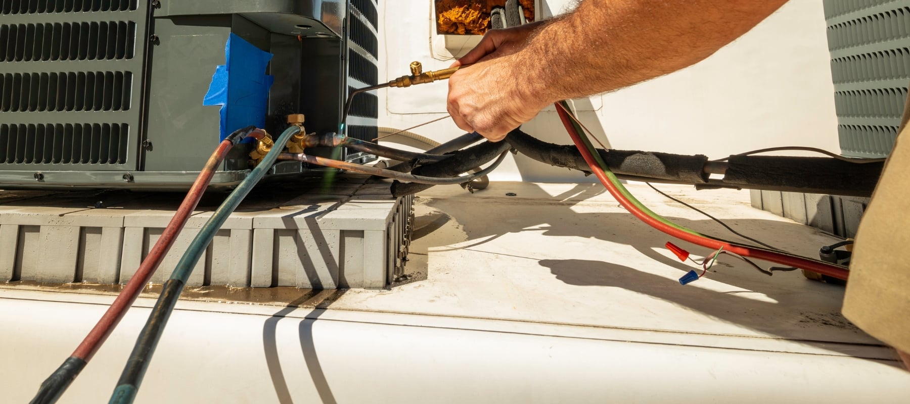 las tech working on a ac unit